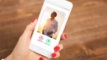 woman looking at man on dating app