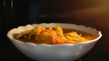 bowl of vegetables cooking in microwave