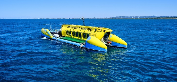 yellow tourist submarine sitting on ocean surface