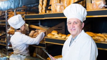 smiling older man working in bakery