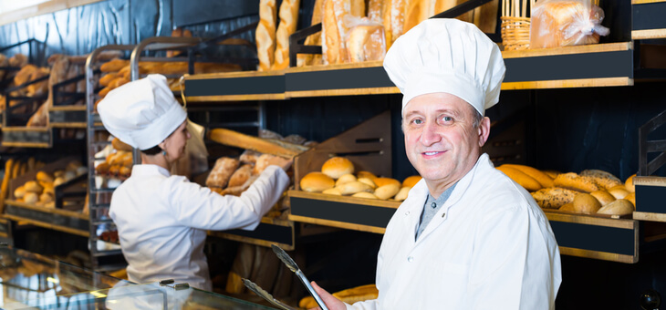 smiling older man working in bakery