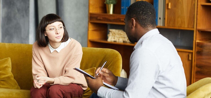 woman in office speaking with therapist