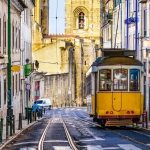 historic yellow tram running in lisbon portugal