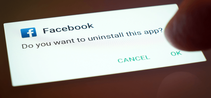 hand holding phone displaying facebook delete notification