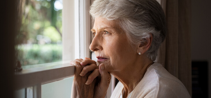 older woman staring out window