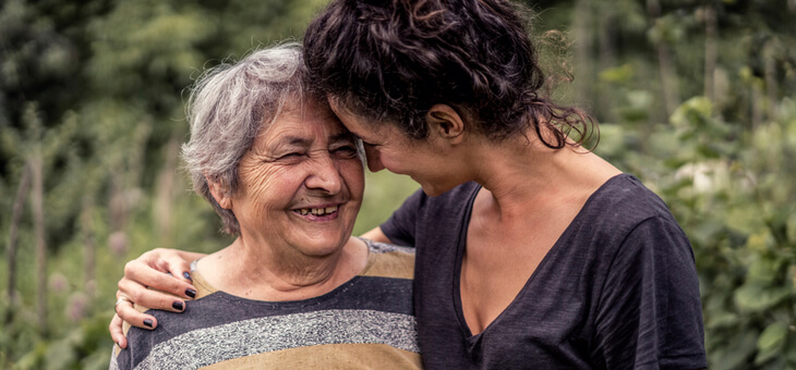 older woman laughing with adult daughter