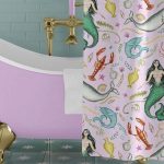 pink clawfoot bathtub with gold feet and mermaid print shower curtain