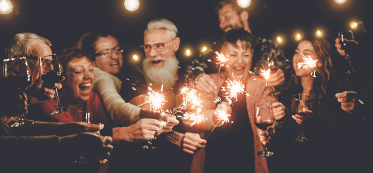 group of older people toasting with glasses