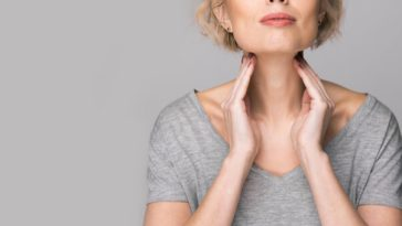woman rubbing glands on neck