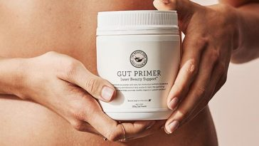 woman holding gut primer supplement