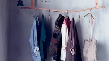clothes hanging on rail made from tree branch