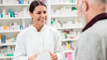 pharmacist giving medicine to patient