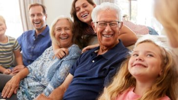 retired couple surrounded by family