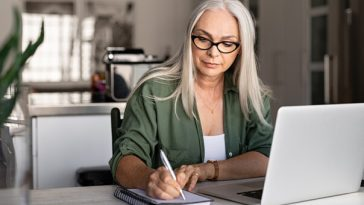 older woman working at laptop
