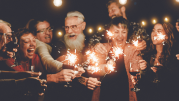 group of older people toasting with glasses