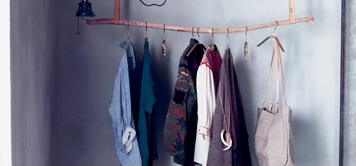 clothes hanging on rail made from tree branch