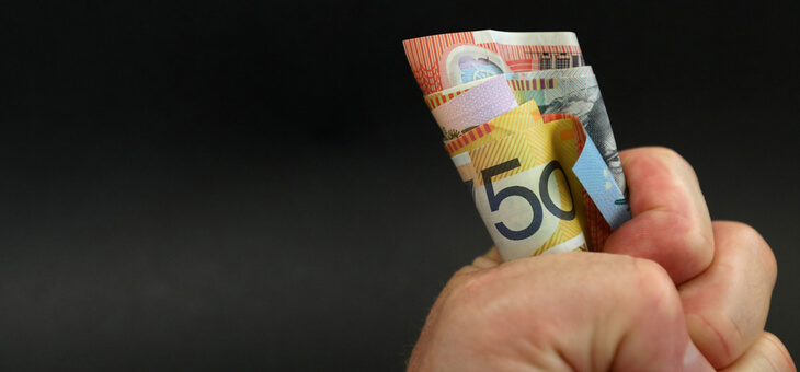 fist holding bunch of australian money