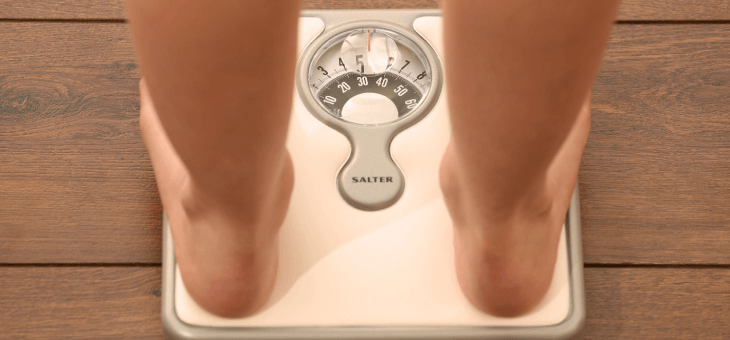 A person weighing themselves