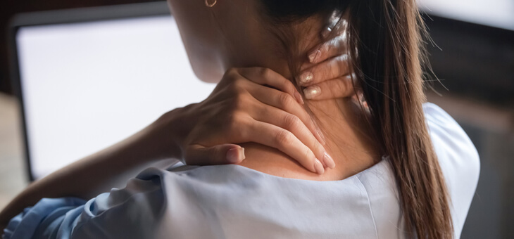 woman rubbing back of neck