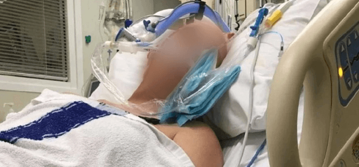 stroke victim in hospital bed with face blurred out