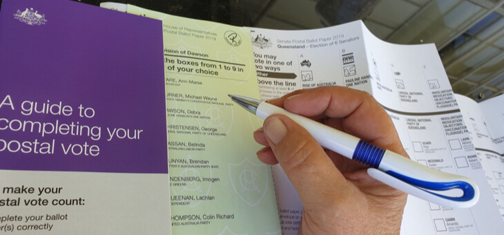 person filling out australian voting form