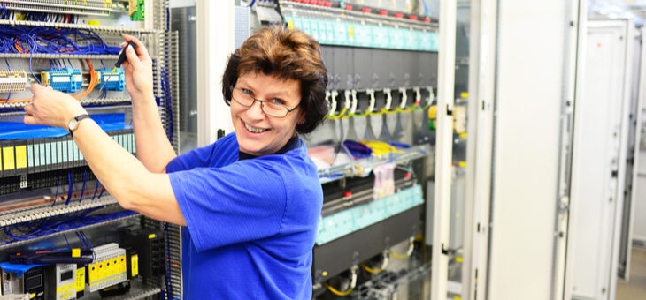 smiling mature woman working in server room