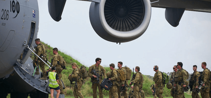 soldiers in uniform boarding military transport plane