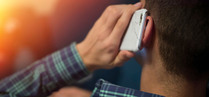 man holding phone up to ear