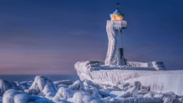 Lighthouse in frozen seascape