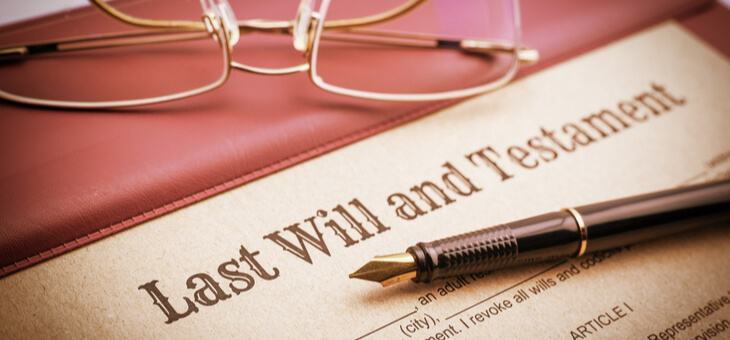 pen resting on last will and testament forms