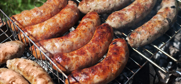 sausages cooking on grill