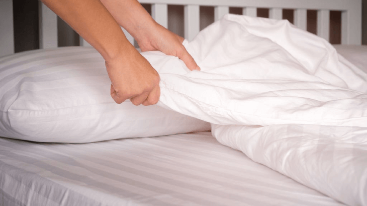 Woman changing the sheets
