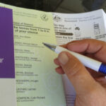 person filling out australian voting form