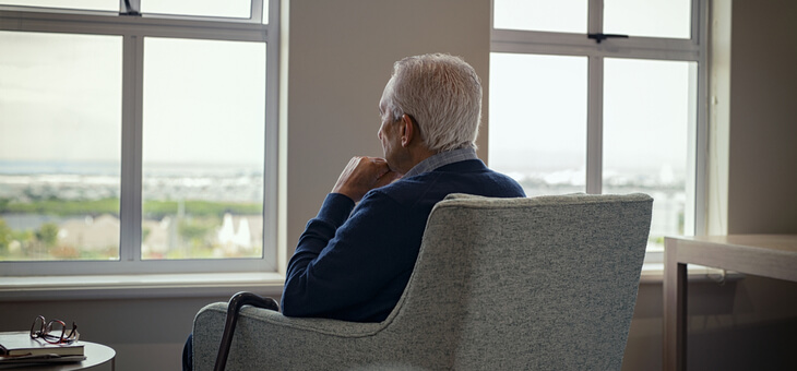 elderly man sitting alone in care home