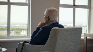 elderly man sitting alone in care home