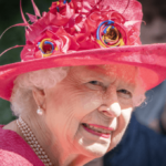 The queen in a rather fetching watermelon-coloured hat