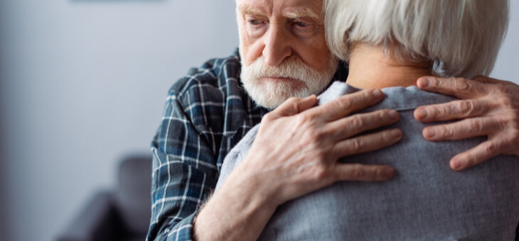 man with dementia hugging woman