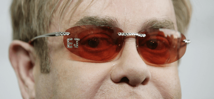 Elton John wearing rose-coloured glasses