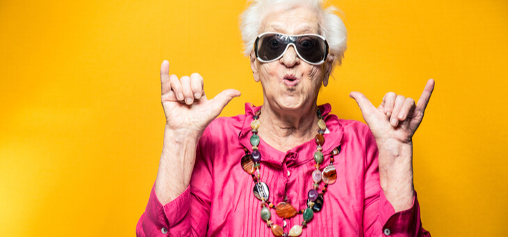 elderly woman in sunglasses celebrating