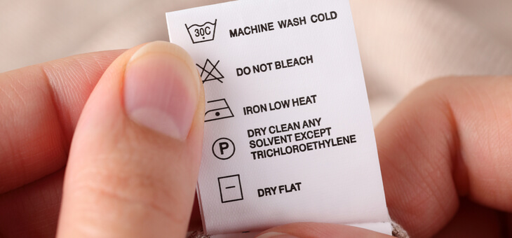 person reading laundry tags