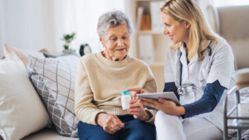 elderly woman speaking to home care nurse