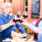 group of older people drinking wine