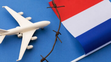 model plane and french flag separated by barbed wire