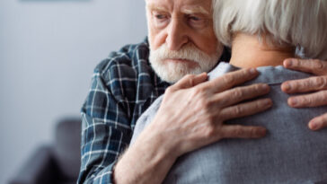man with dementia hugging woman