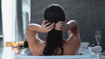Woman washing her hair in the bath