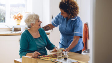 elderly woman receiving home care from nurse