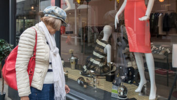 older lady looking at clothes in shop window