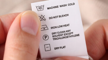 person reading laundry tags