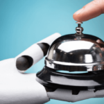 Man ringing hotel desk bell held by a robot