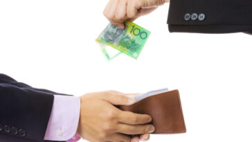 man putting $100 in another man's wallet